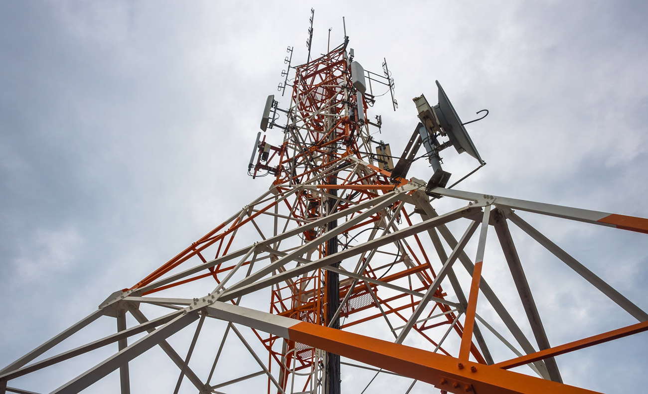 Telecommunication tower with TV, microwave and panel antennas, and satellite dishes